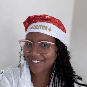 Red personalised Santa hat with gold snowflakes and custom name printed on rim.