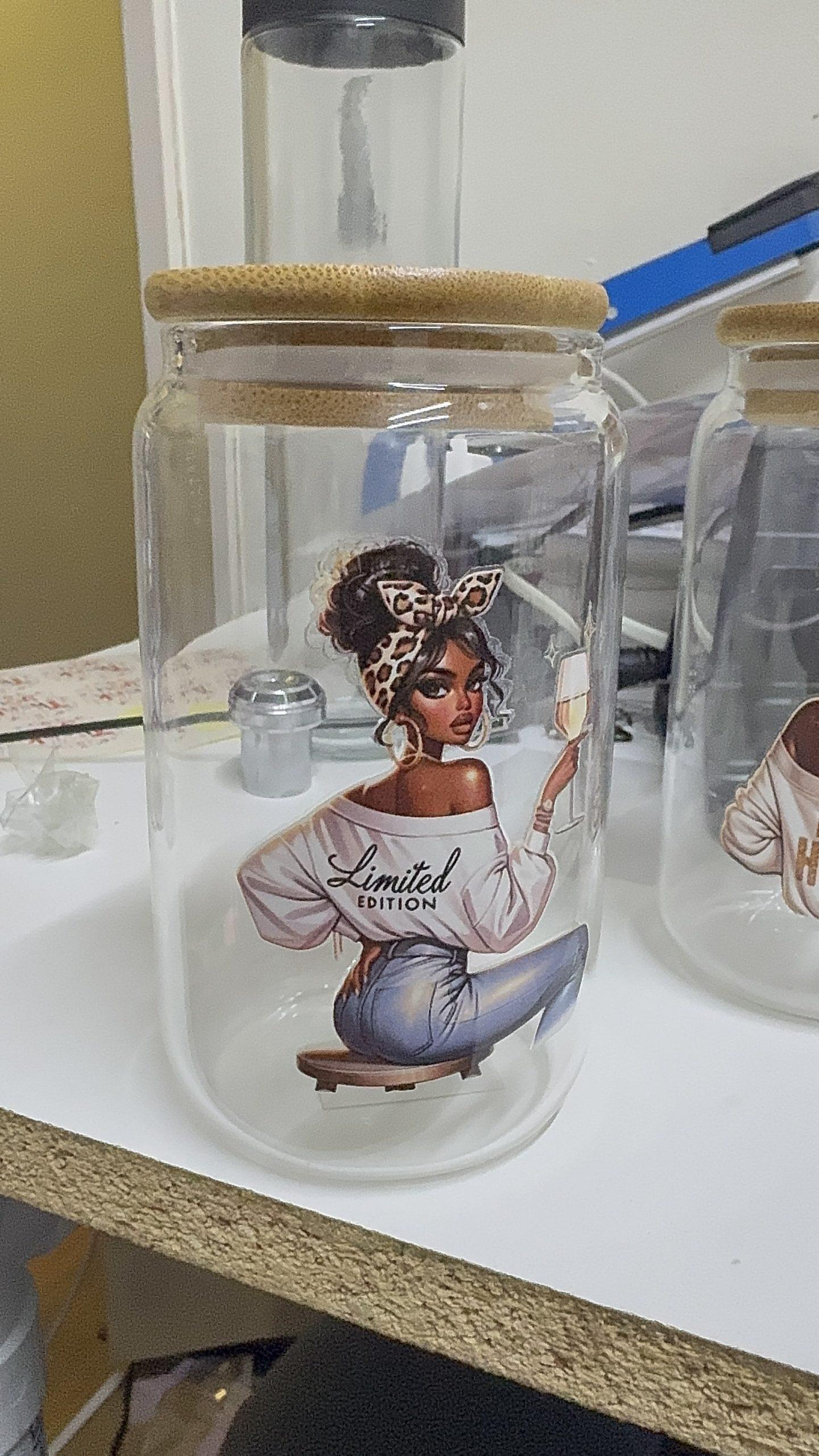 Clear glass jar with a wooden lid, featuring a graphic of a "Limited Edition" woman sitting with a champagne glass.